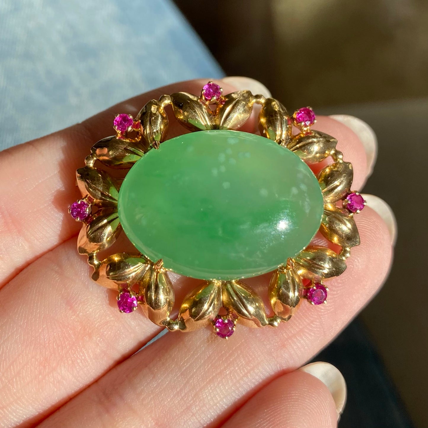 Tiffany & Co. 1940s 14KT Yellow Gold Jade & Ruby Brooch front view in hand