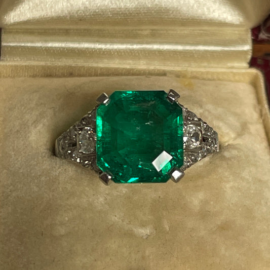 Art Deco Platinum Colombian Emerald Ring front view in jewelry boc
