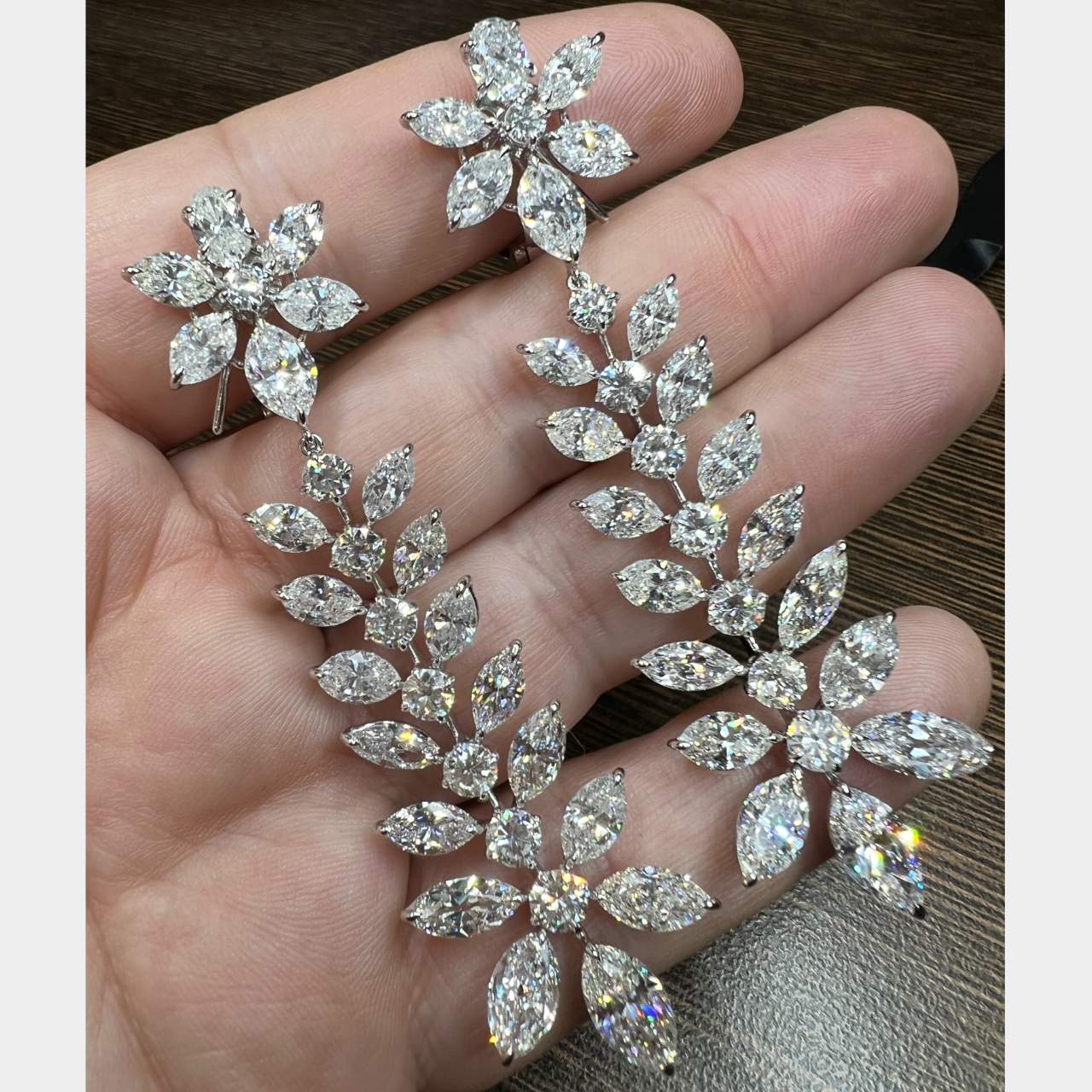 Sophia D. Post-1980s Platinum Diamond Chandelier Earrings front view held in hand