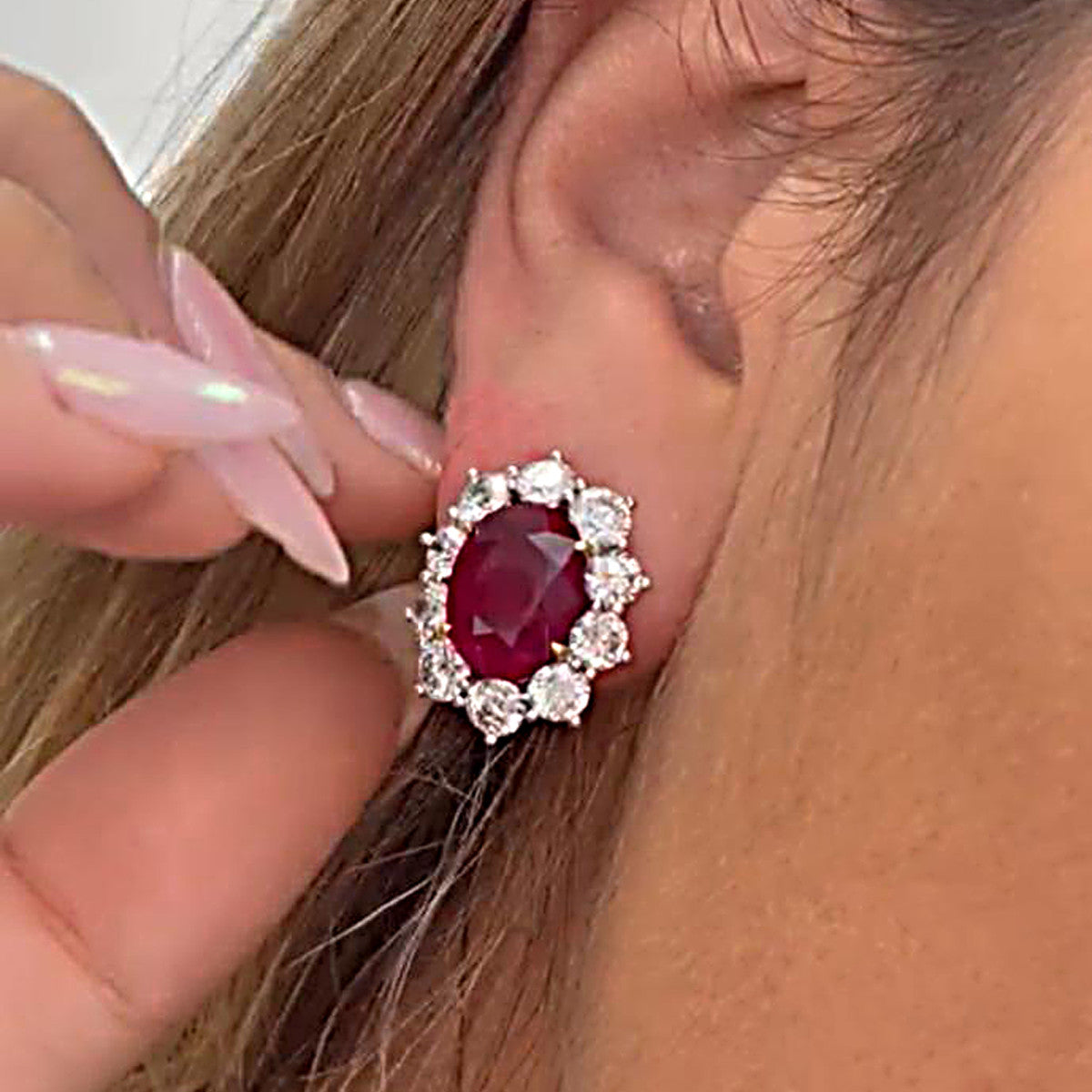 Contemporary Platinum Ruby & Diamond Earrings worn on ear