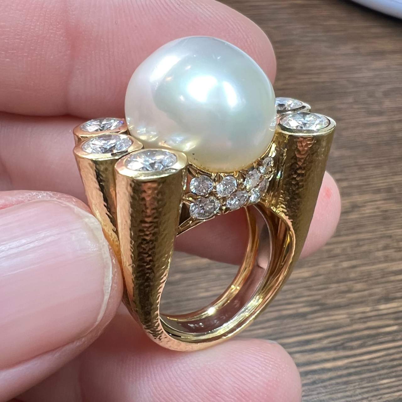 David Webb Post-1980s Platinum & 18KT Yellow Gold Cultured Pearl & Diamond Ring profile view in hand