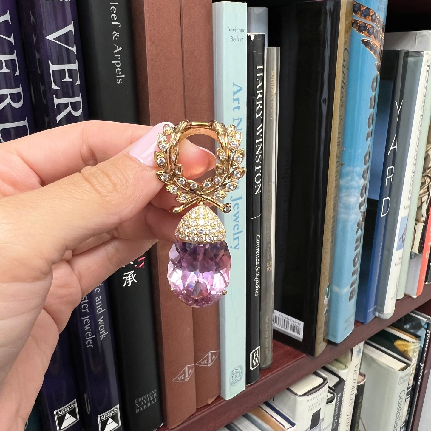 1970s 18KT Yellow Gold Diamond & Kunzite Pendant front view in hand