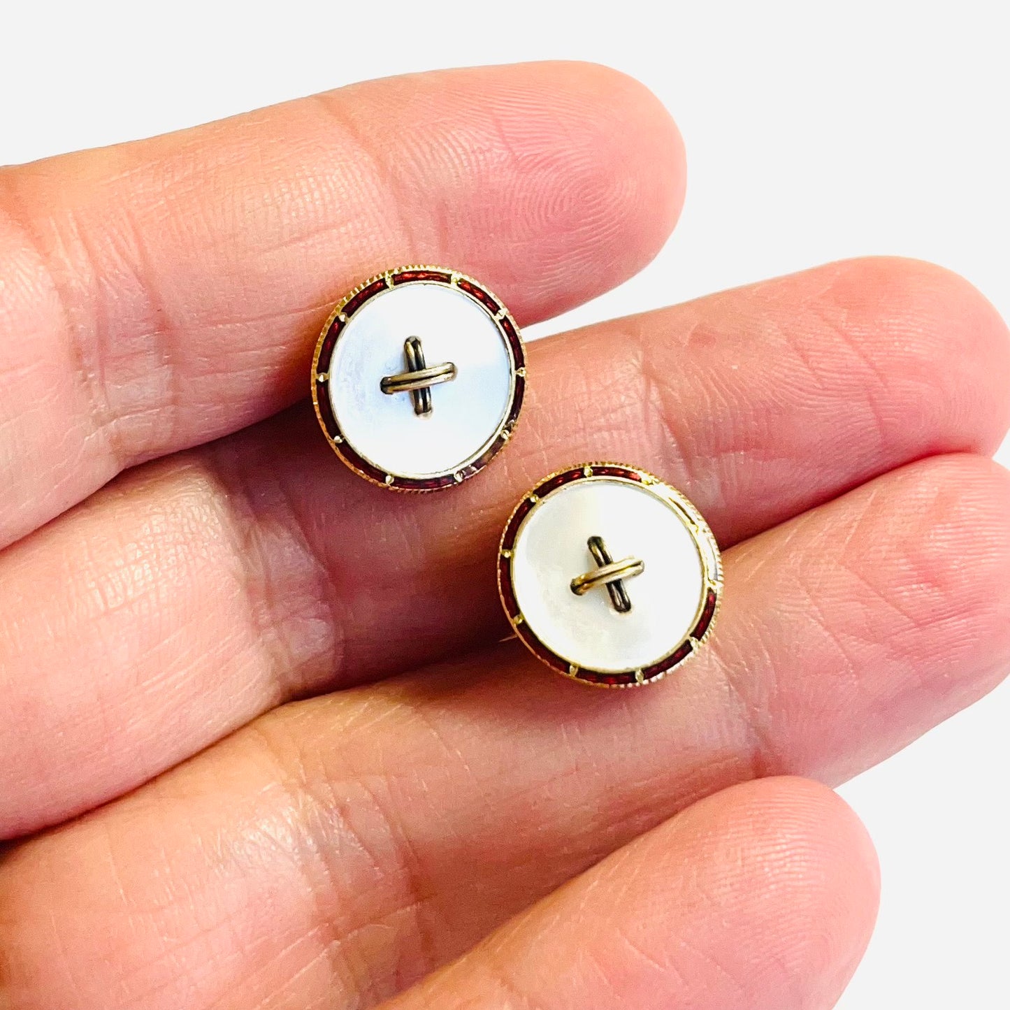 Edwardian 14KT Yellow Gold Mother of Pearl & Enamel Cufflinks in hand