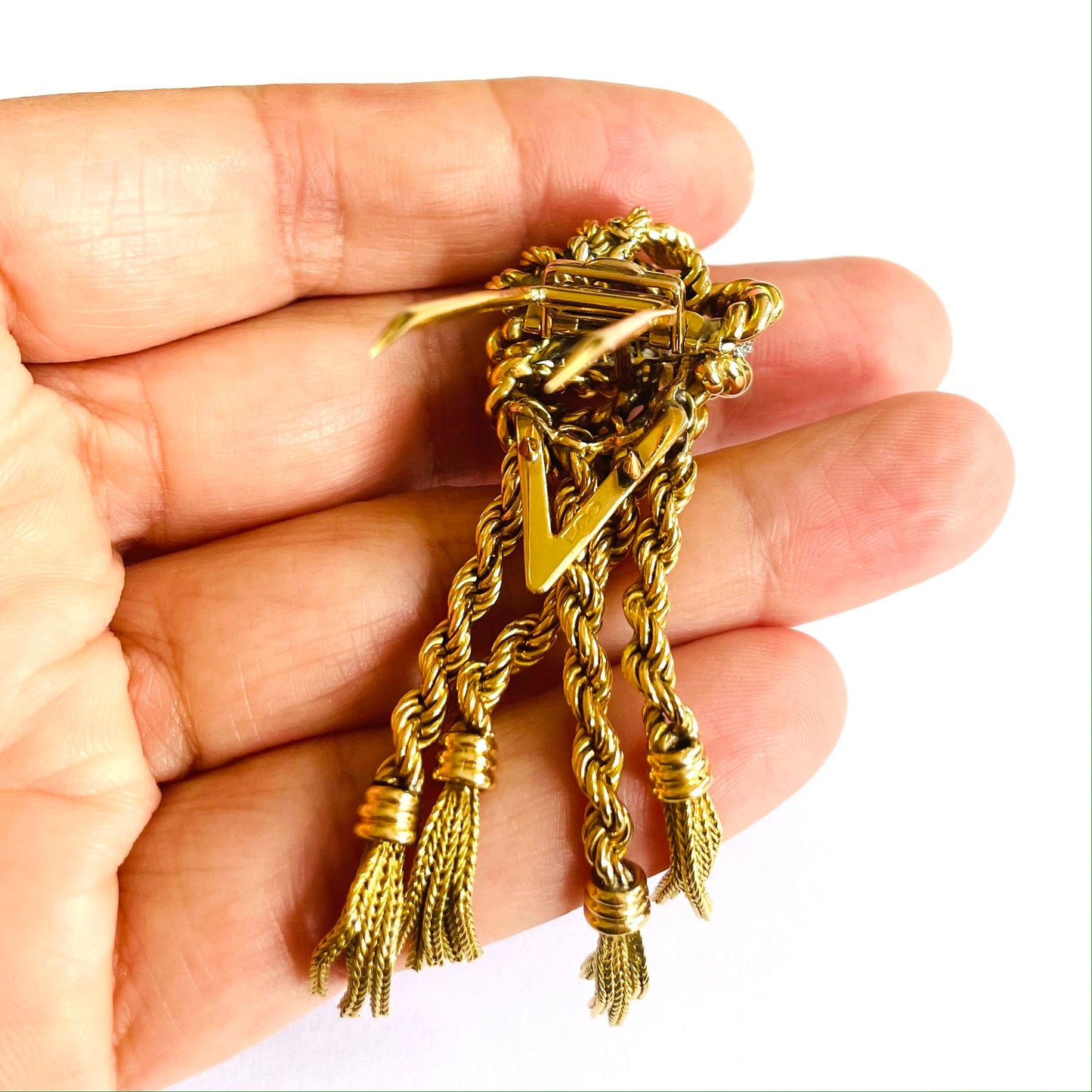 French 1940s 18KT Yellow Gold Diamond Tassel Brooch in hand