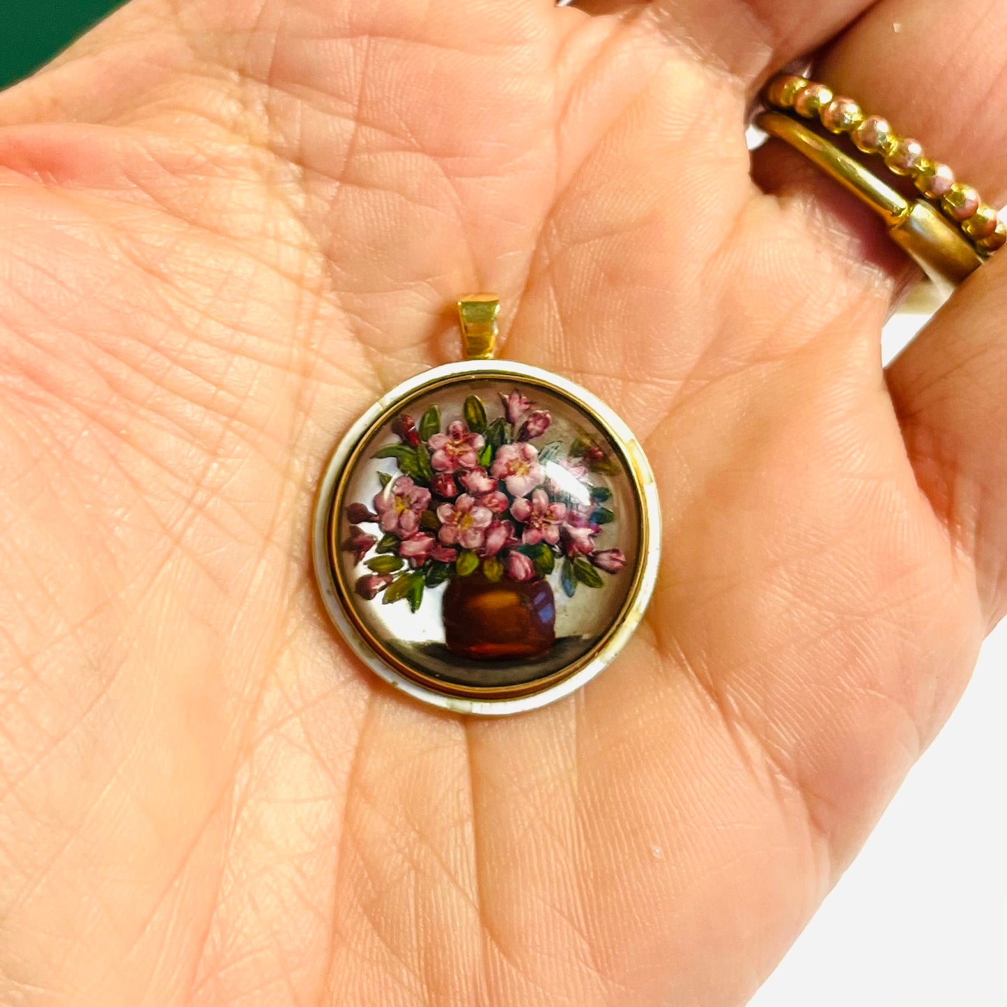 Victorian 18KT Yellow Gold Rock Crystal, Enamel & Mother of Pearl Pendant in hand