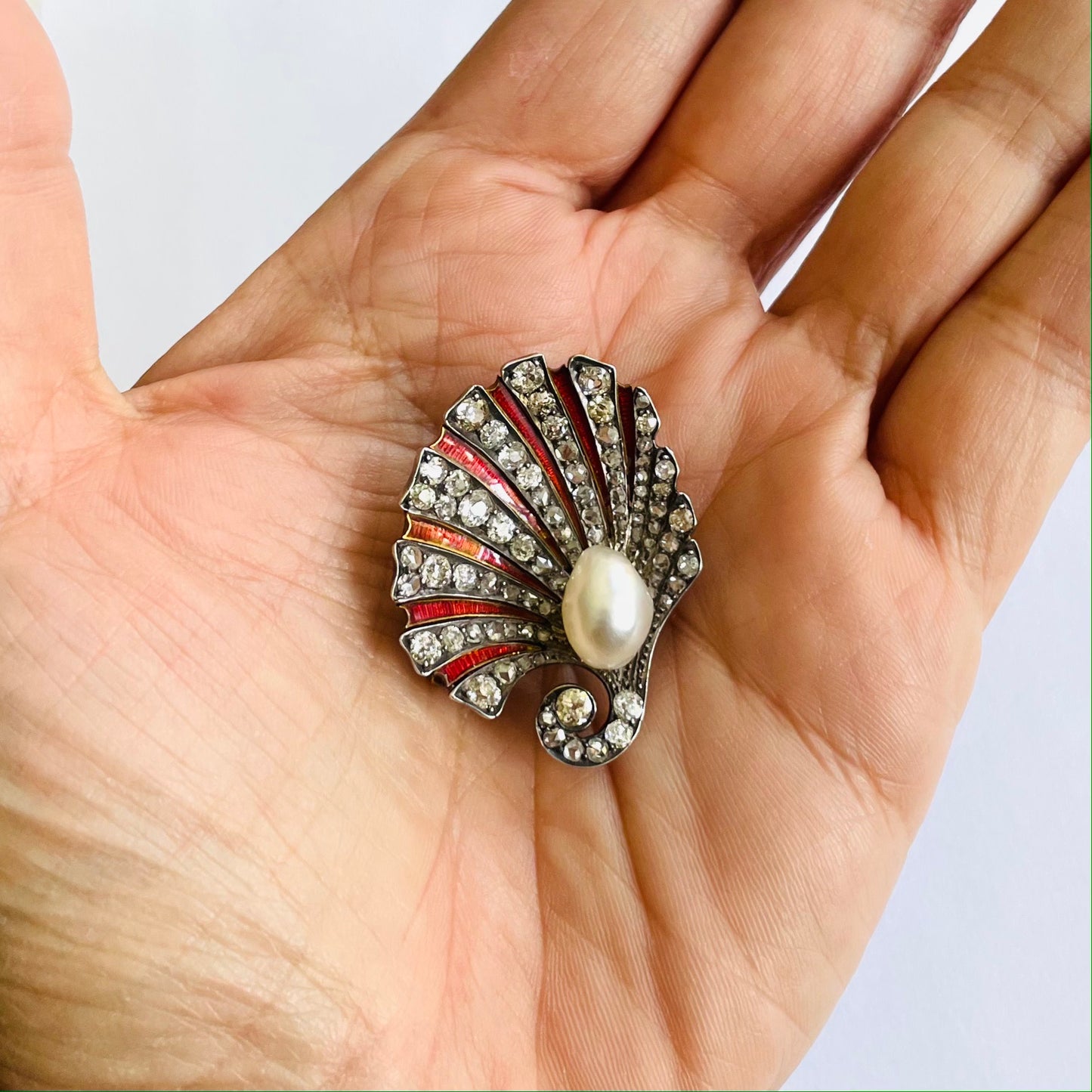 Antique Silver & 18KT Yellow Gold Natural Pearl, Diamond & Enamel Shell Brooch in hand