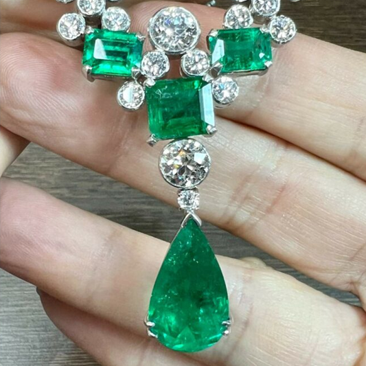1950s Platinum Emerald & Diamond Necklace close-up in hand