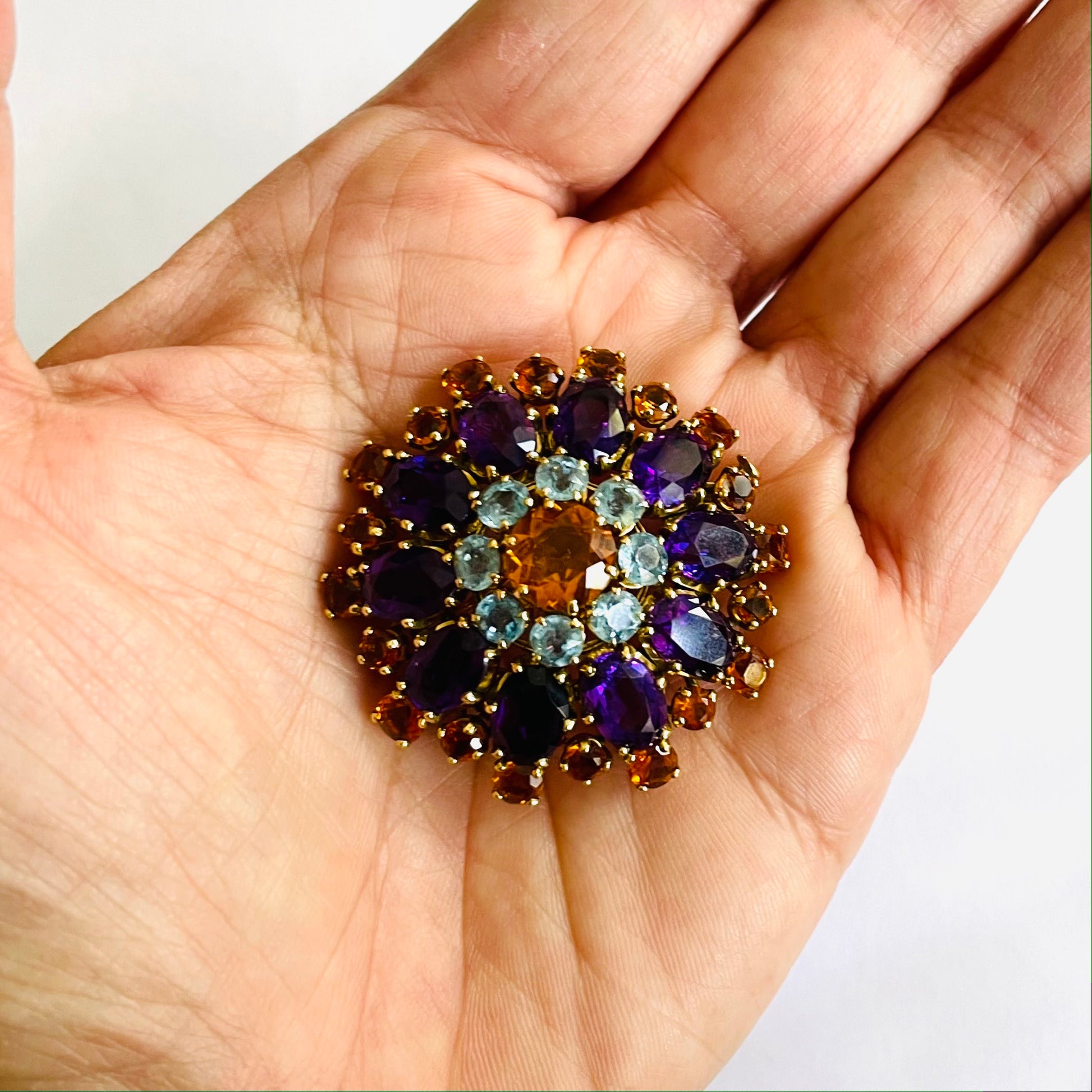Mellerio French 1960s 18KT Yellow Gold Amethyst, Aquamarine & Citrine Brooch in hand