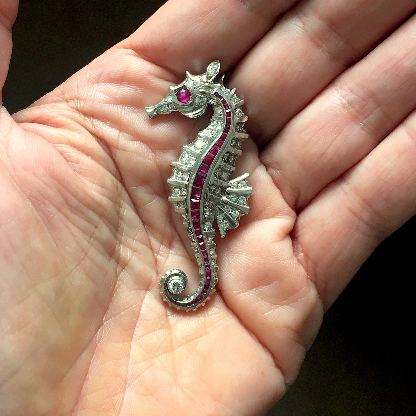 Fontana 1930s Rhodium Plated Ruby & Diamond Seahorse Brooch in hand