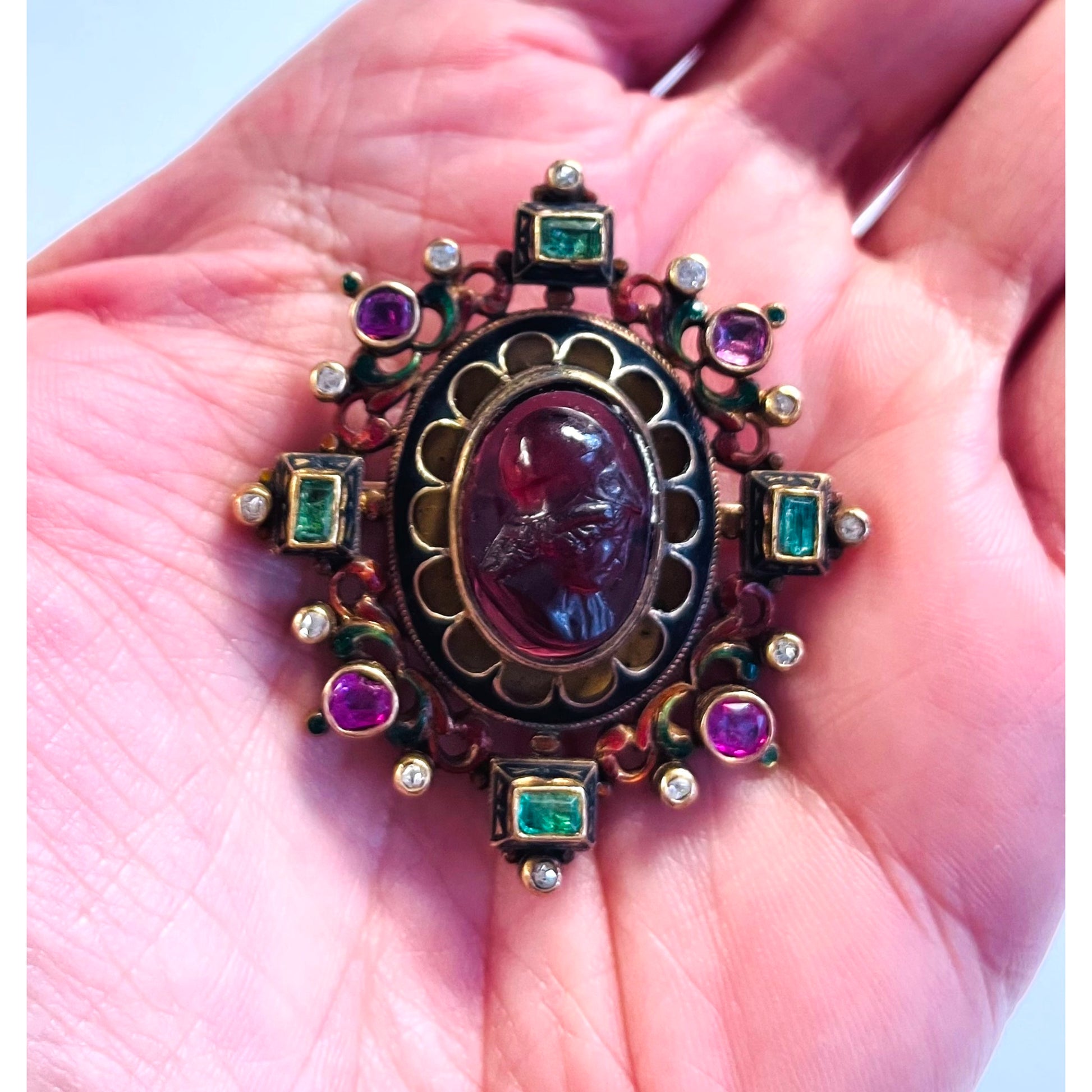 Antique Renaissance Revival 14KT Yellow Gold Garnet, Diamond, Emerald, Enamel & Ruby Brooch in hand