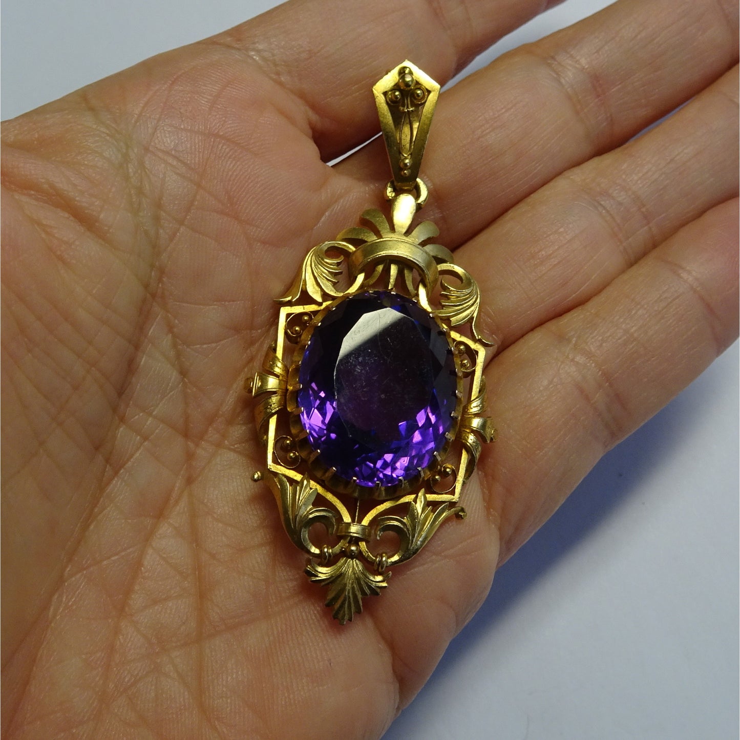 Art Nouveau 18KT Yellow Gold Amethyst Pendant in hand