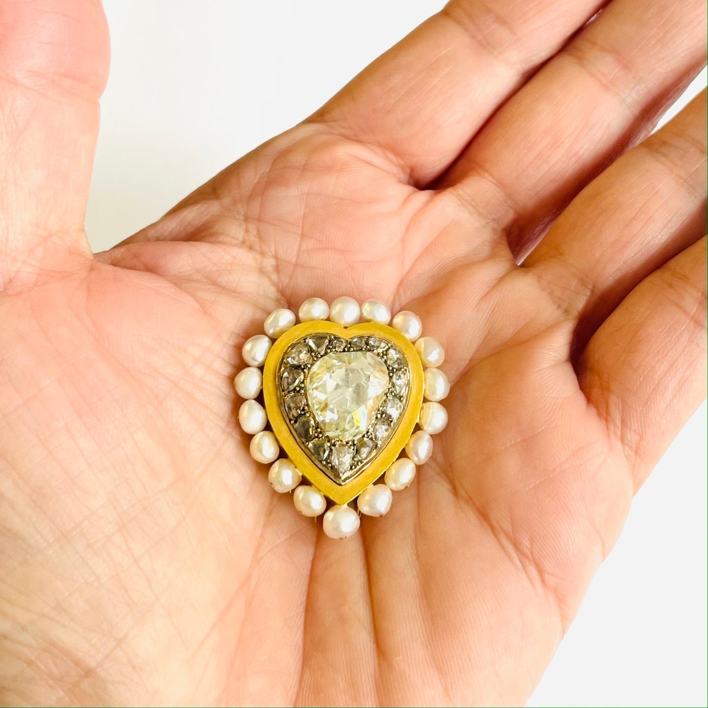 French Antique 18KT Yellow Gold Diamond & Pearl Heart Brooch in hand