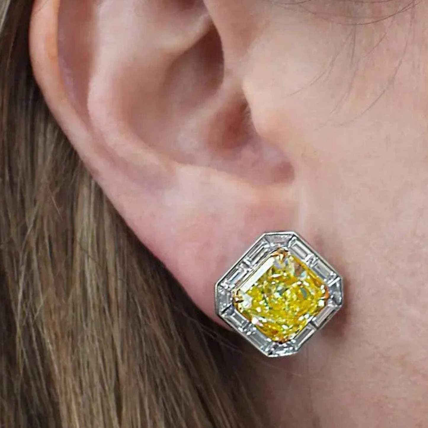 Contemporary Platinum White & Yellow Diamond Earrings on ear
