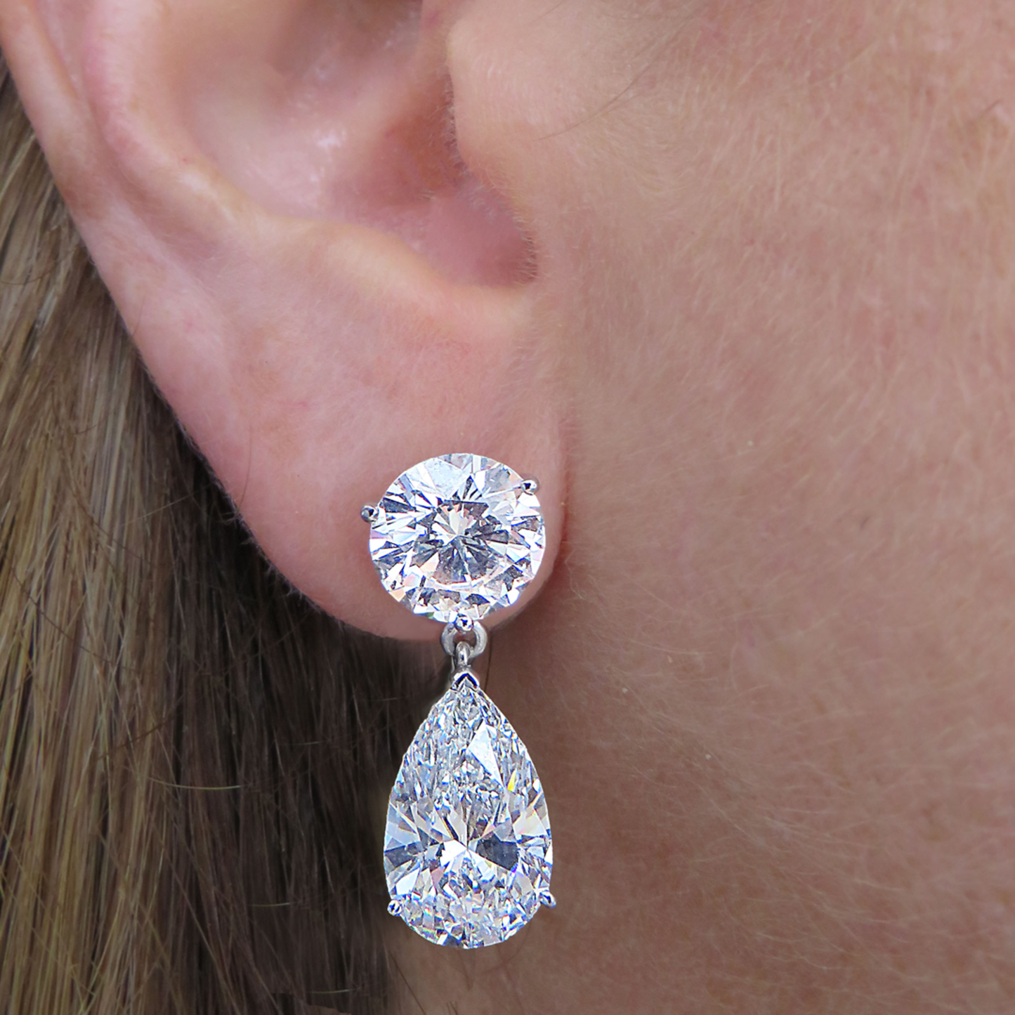 Contemporary Platinum Diamond Earrings on ear