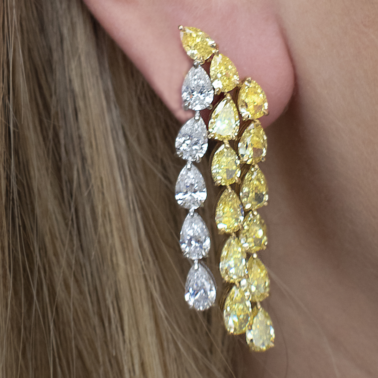 Contemporary 18KT Yellow Gold Diamond Earrings on ear