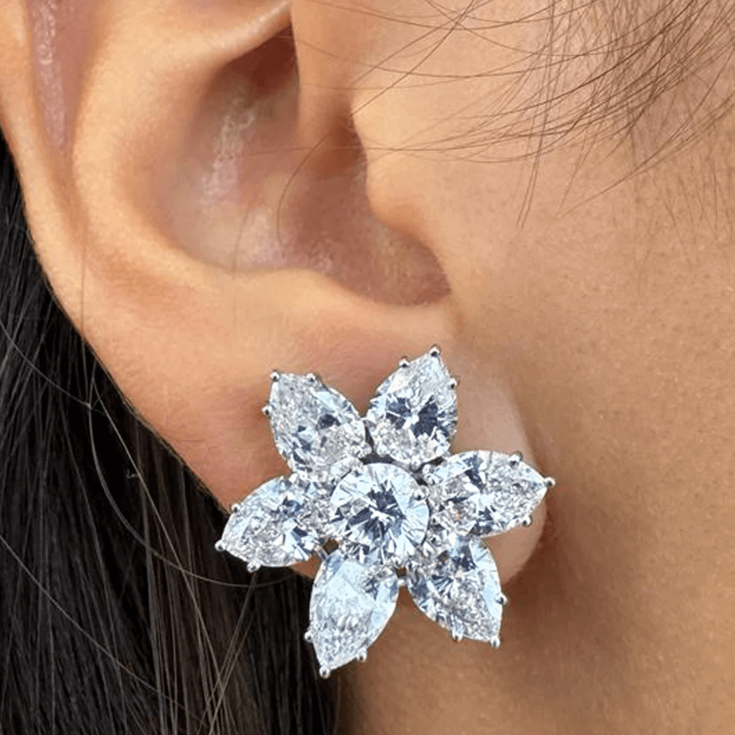 Contemporary Platinum Diamond Earrings on ear