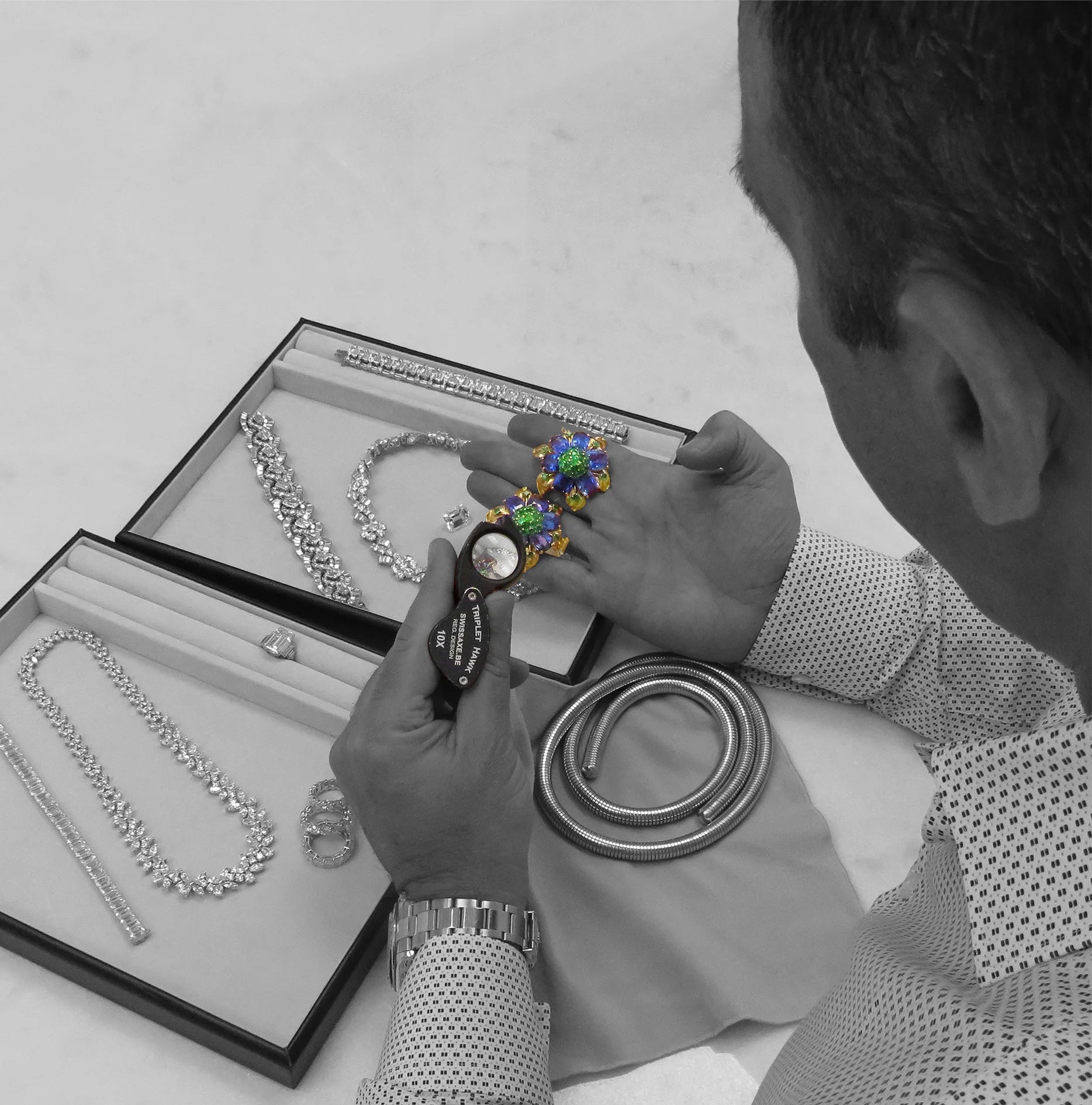 inspecting jewelry at Vivid Diamonds