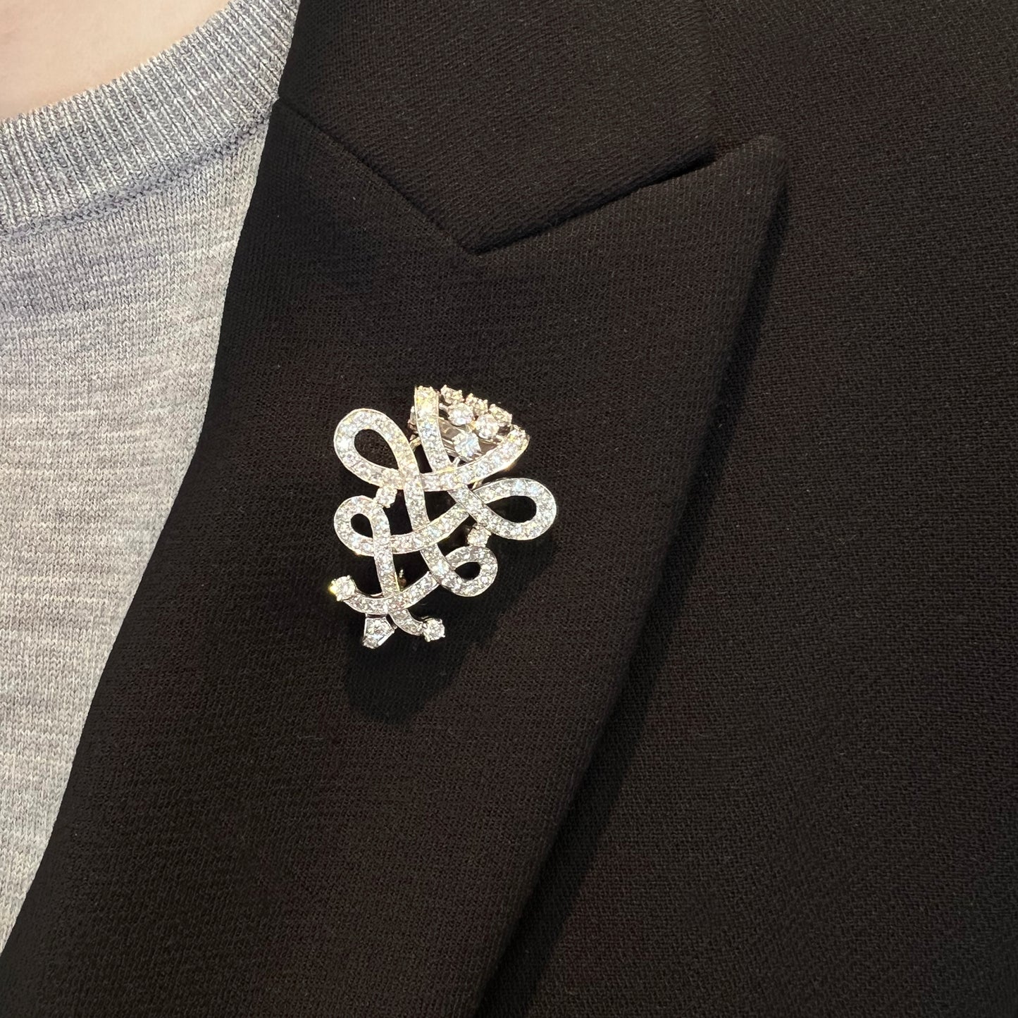 Cartier 1950s Platinum Diamond Brooch worn on black collar
