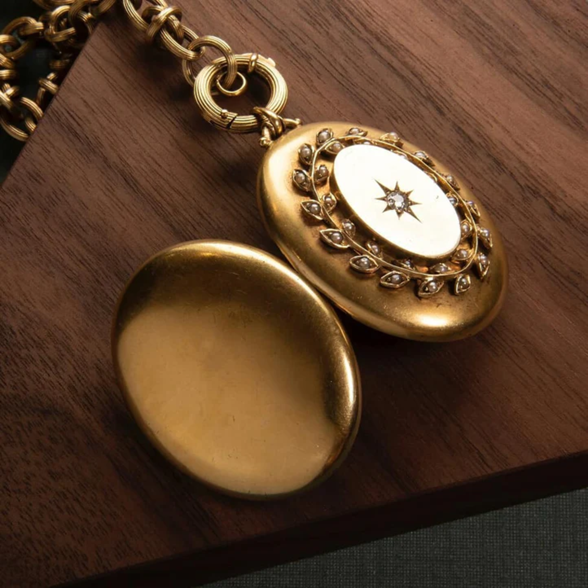 Victorian 18KT Yellow Gold Diamond & Seed Pearl Locket Necklace back view on desk