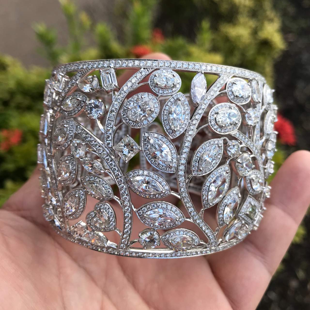 1980s 18KT White Gold Diamond Cuff Bracelet in hand