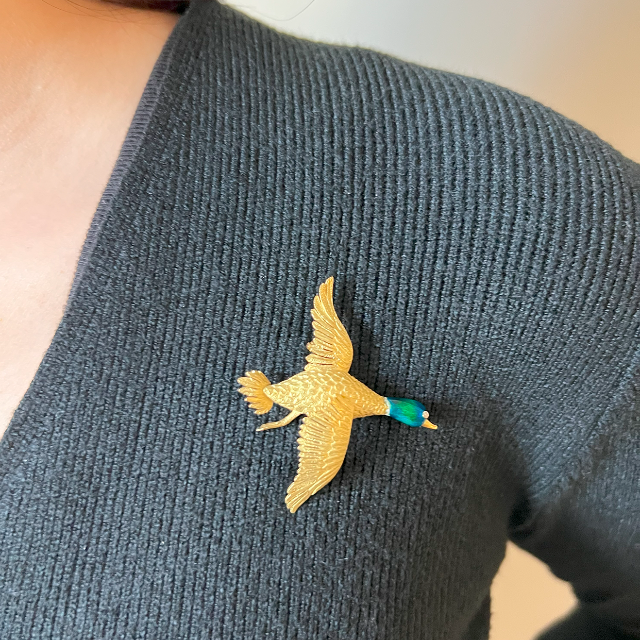 Mellerio 1950s 18KT Yellow Gold Duck Brooch worn on gray blouse