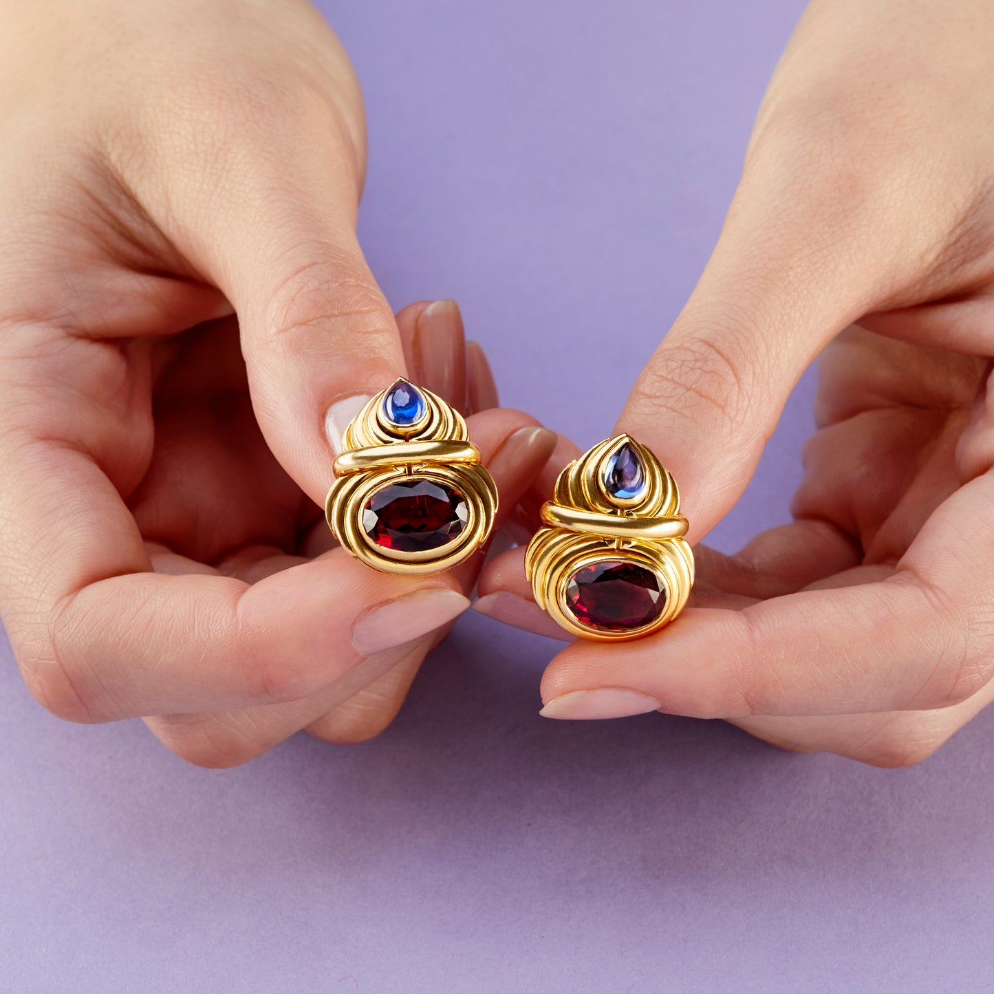 Bulgari 1980s 18KT Yellow Gold Rubellite Tourmaline & Sapphire Earrings in hand