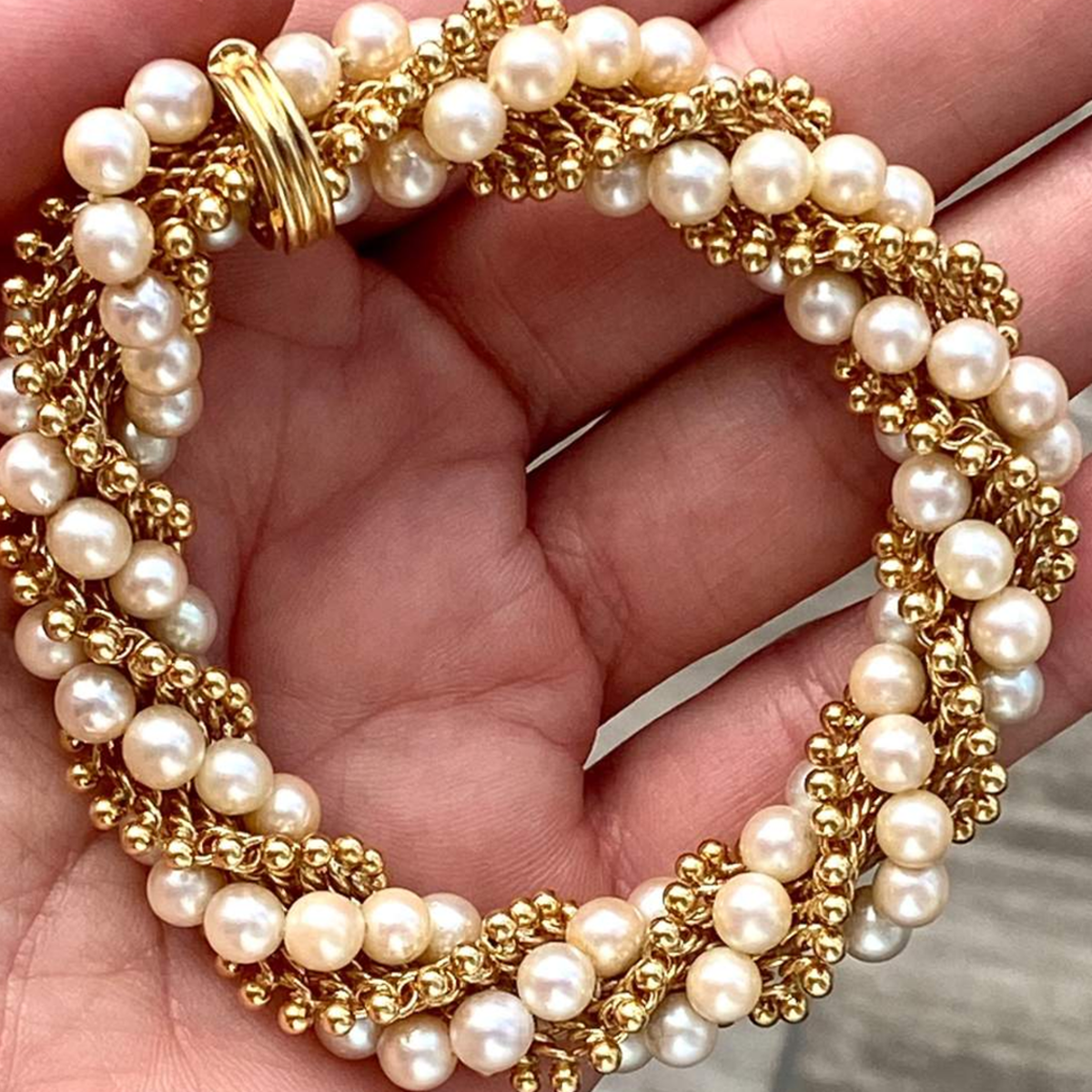 Van Cleef & Arpels Paris Post-1980s 18KT Yellow Gold Pearl & Gold Bracelet in hand