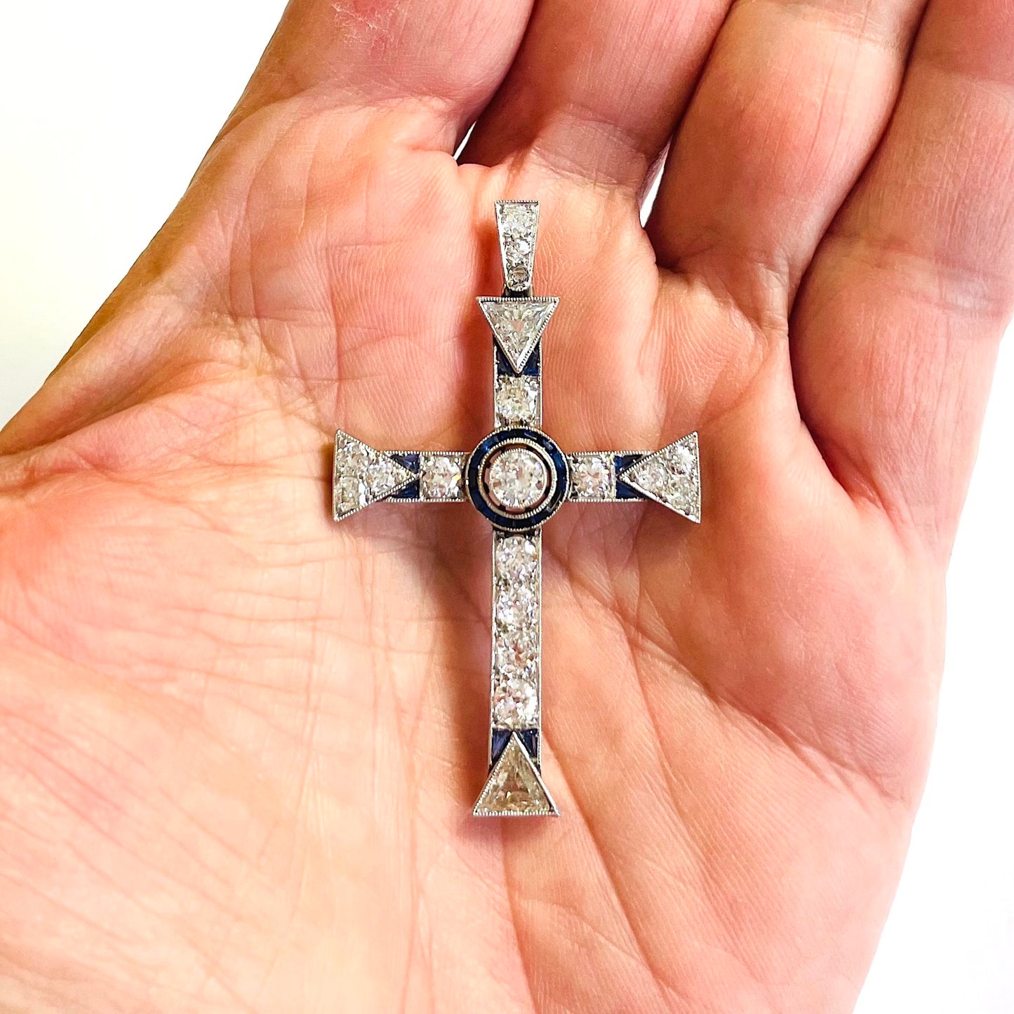Edwardian Platinum & 18KT Yellow Gold Diamond & Sapphire Cross Pendant in hand