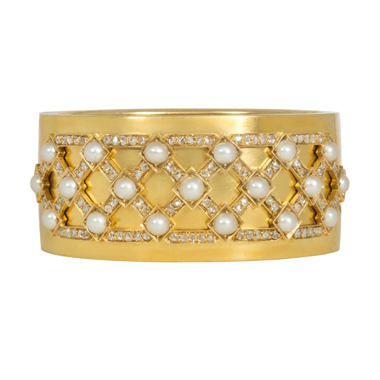 Victorian 15-karat gold bangle with a lattice of diamonds and natural pearls, English, inscribed “wedding present to Margaret Leicester Warren from the Galley Genantry, 1875”. 