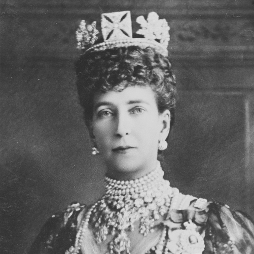 Bust-length formal portrait photograph of Queen Alexandra wearing King George IV's Diamond Circlet, Royal Family Orders, crown and other pieces of jewelry, circa 1905, Public Domain, courtesy Wikimedia. 