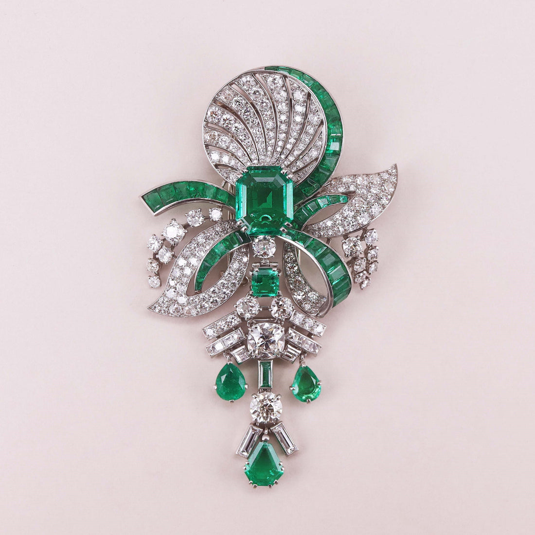 Art Deco diamond, 5.59-carat Colombian emerald and 18-karat white-gold brooch, signed Mauboussin, accompanied by an SSEF Report for the central emerald.