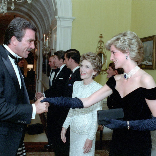 Princess Diana is greeted by Tom Selleck in The Residence during a private dinner, November 9, 1985, White House Photographic Collection, public domain, courtesy WikiCommons.