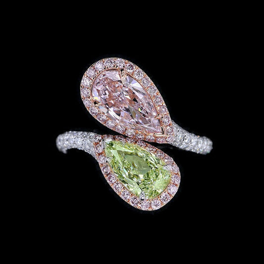 Fancy purplish pink and fancy Light yellow-green pear shape diamonds mounted in 18-karat gold, accompanied by a GIA report.