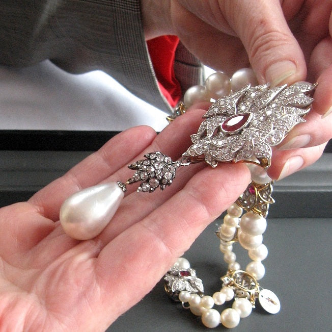 “La Peregrina: An Extraordinary Renaissance Pearl” author Annemarie Jordan, holds La Peregrina in her hand before it was auctioned at Christie’s New York sale of Elizabeth Taylor’s jewelry in December 2011.  