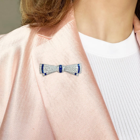 Art Deco Platinum Sapphire Diamond Bow Brooch worn on pink collar