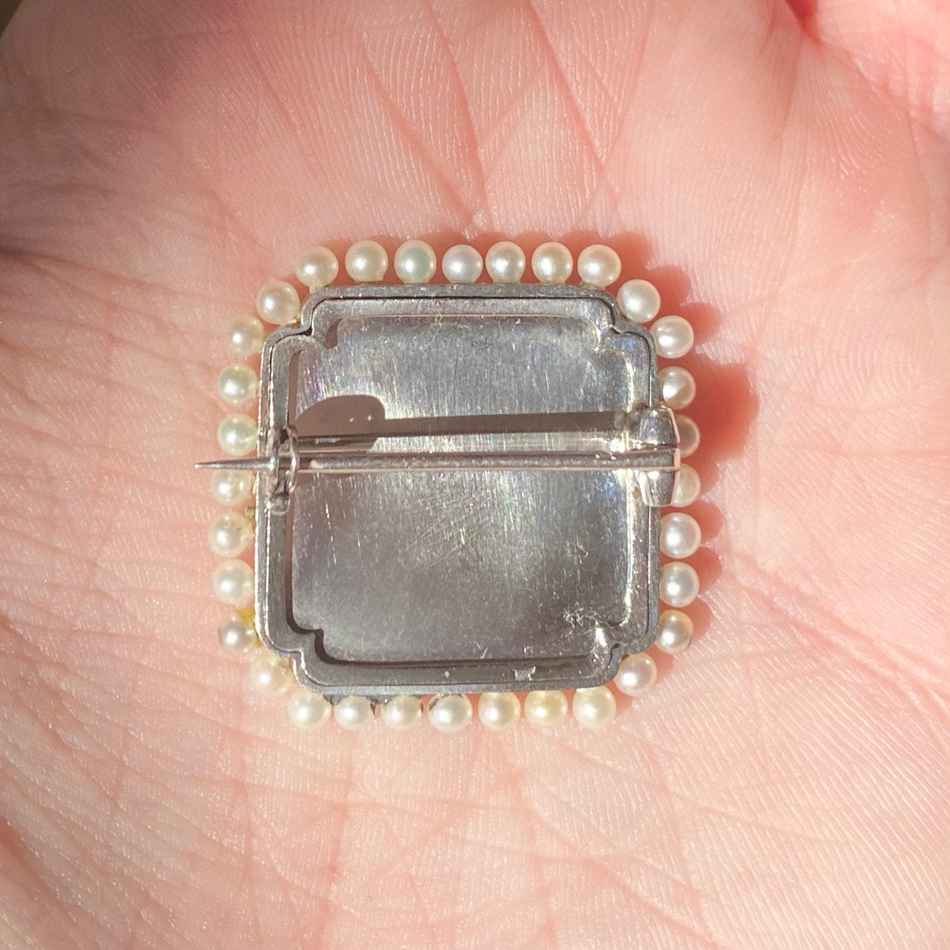 Edwardian Platinum Diamond, Natural Pearl & Carved Crystal Brooch back view in hand 