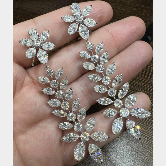 Sophia D. Post-1980s Platinum Diamond Chandelier Earrings front view held in hand