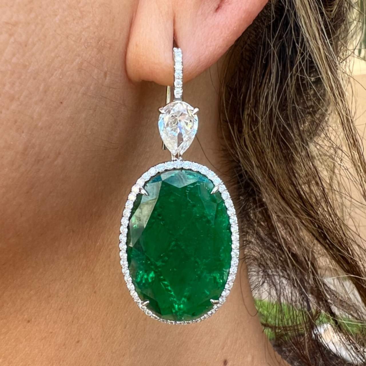 1990s Platinum Emerald & Diamond Earrings worn on ear