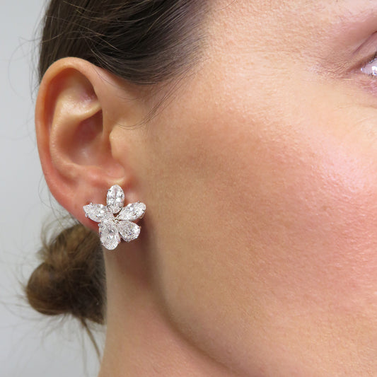 Contemporary Platinum Diamond Earrings on ear