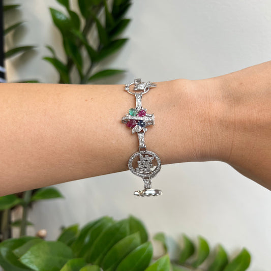 Art Deco Platinum Diamond, Emerald, Ruby & Sapphire Charm Bracelet worn on wrist