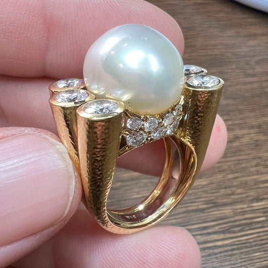 David Webb Post-1980s 18KT Yellow Gold & Platinum Natural Pearl & Diamond Ring profile view in hand