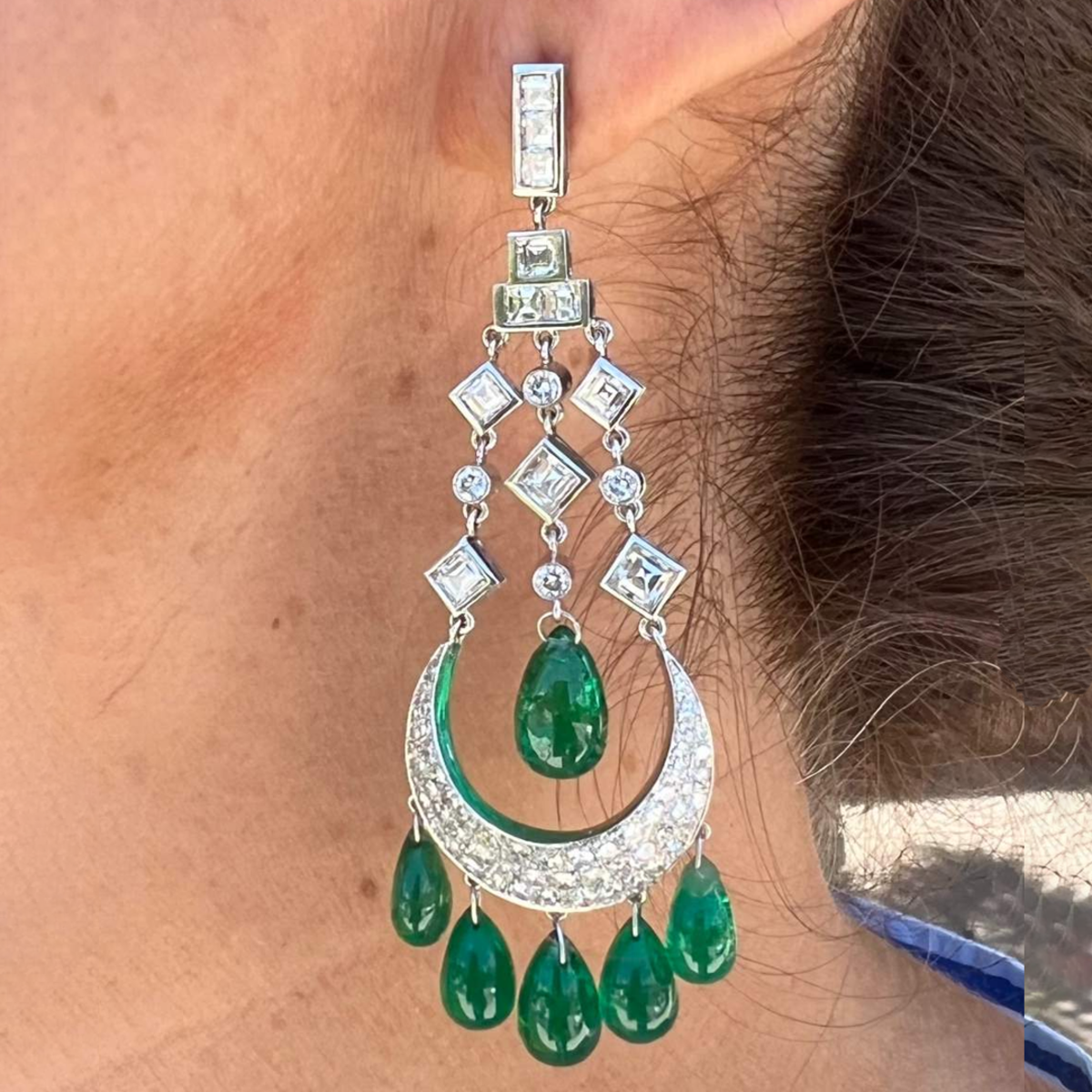 Post-1980s Platinum Diamond & Emerald Chandelier Earrings worn on ear