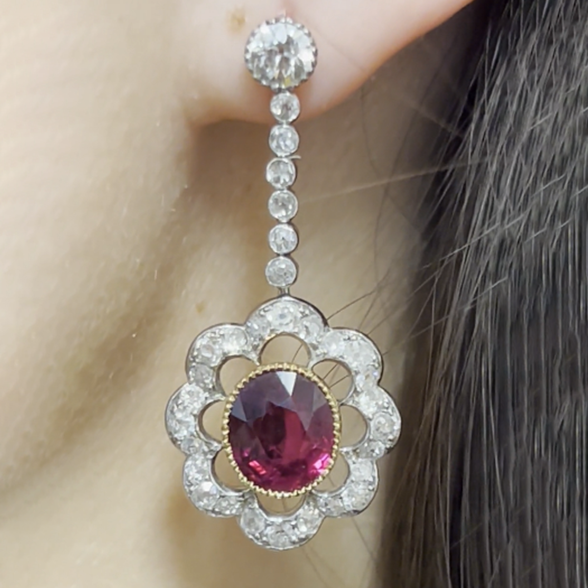 Edwardian Platinum & 18KT Yellow Gold Ruby & Diamond Earrings close-up on ear