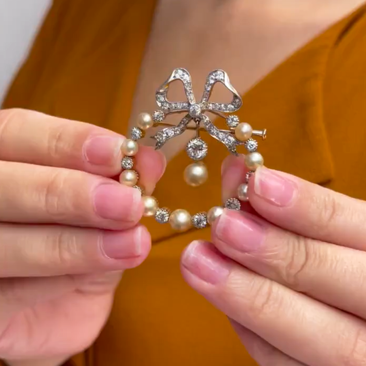 Edwardian Platinum Diamond & Natural Pearl Brooch in hands