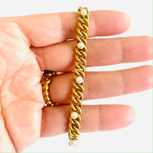 French 1930s 18KT Yellow Gold Natural Pearl Bracelet in hand