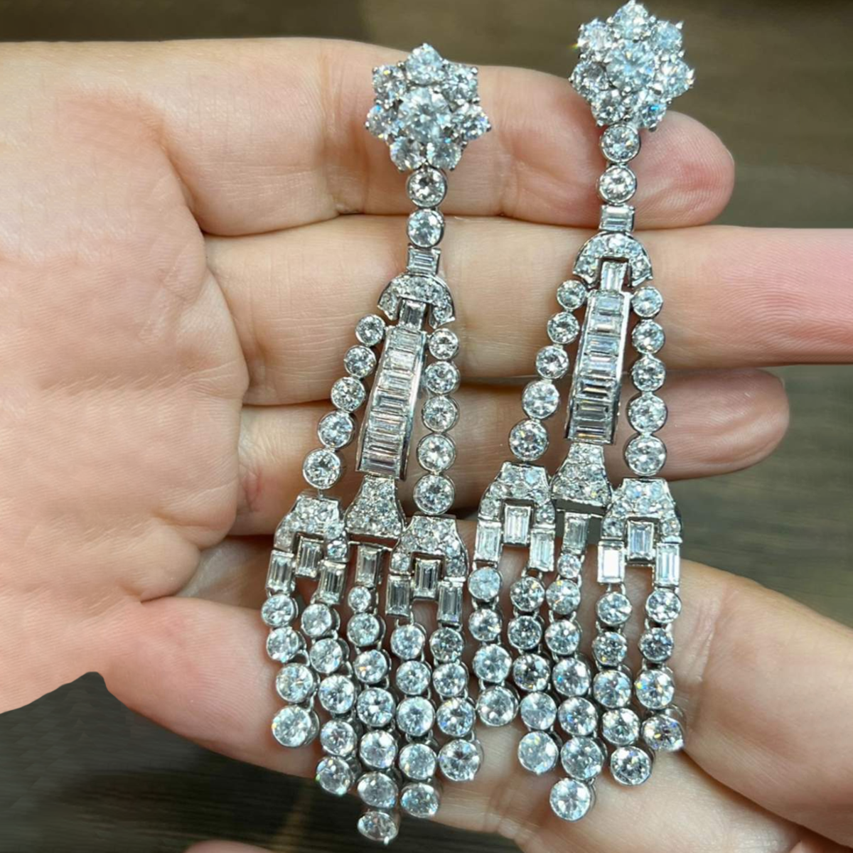 Post-1980s Platinum Diamond Chandelier Earrings in hand
