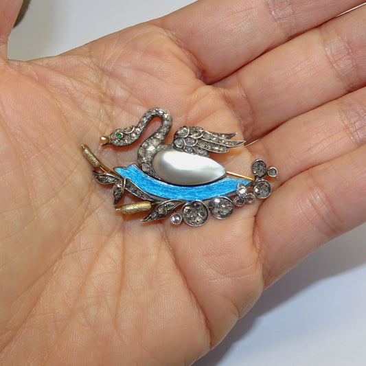 Antique Silver & 18KT Yellow Gold Diamond, Emerald, Enamel & Natural Pearl Swan Brooch in hand
