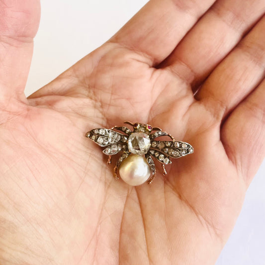 Antique Silver & 18KT Yellow Gold Diamond, Natural Pearl & Ruby Moth Brooch in hand