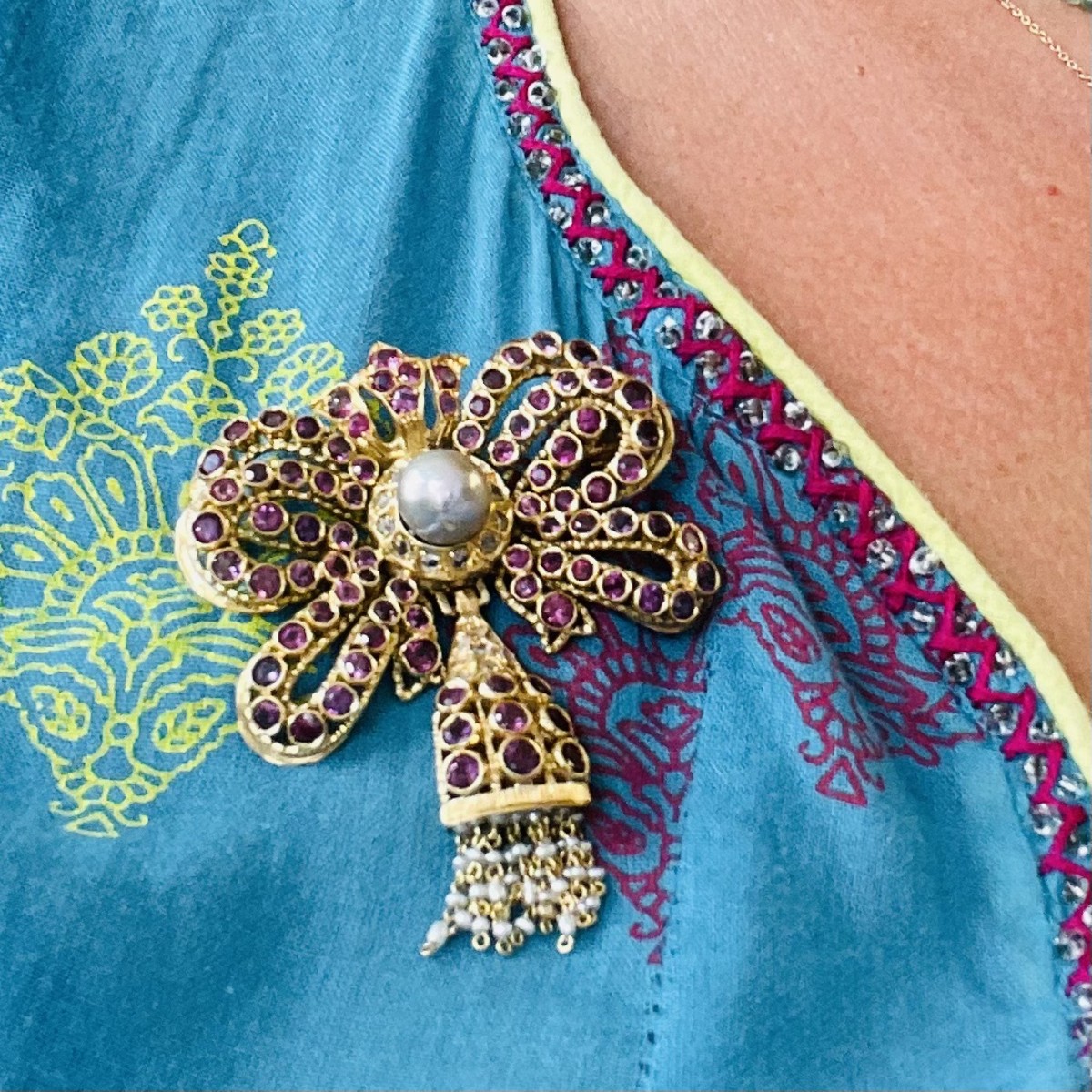 1960s 18KT Yellow Gold Ruby, Diamond & Cultured Pearl Bow Brooch worn on shirt