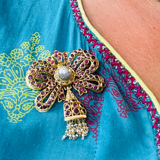 1960s 18KT Yellow Gold Ruby, Diamond & Cultured Pearl Bow Brooch worn on shirt